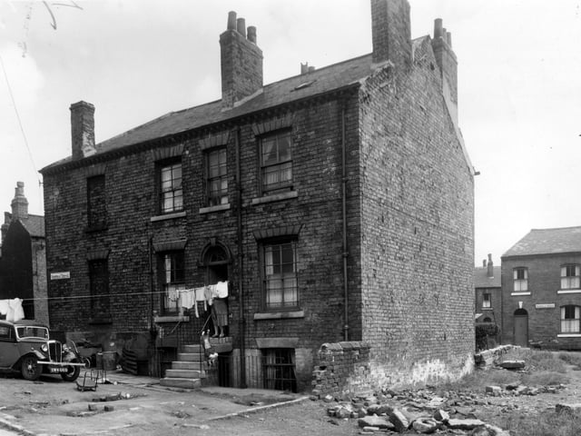 Sheepscar Terrace is in an area where some demolition had taken place in July 1958. The house to the left is bricked up. Sackville Street was on the other side of these houses.