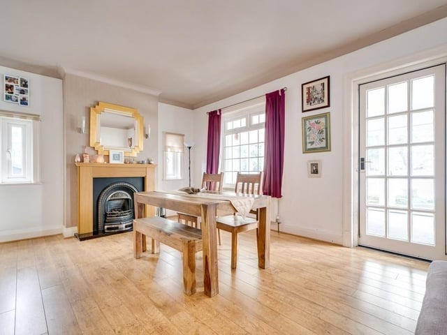 The cast iron, wood and marble fireplace is a feature within the dining room.