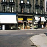 Cheapside, Morley Bottoms, looking directly past the traffic lights at the bottom of Scatcherd Hill. Some of the old Edwardian names still appear over two of the shops, but of the modern names only that of Norman Fox, the ironmonger, is easy to distinguish. Pictured in August 1967.