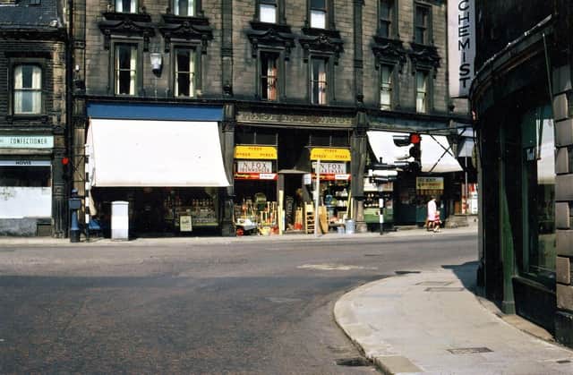 Cheapside, Morley Bottoms, looking directly past the traffic lights at the bottom of Scatcherd Hill. Some of the old Edwardian names still appear over two of the shops, but of the modern names only that of Norman Fox, the ironmonger, is easy to distinguish. Pictured in August 1967.