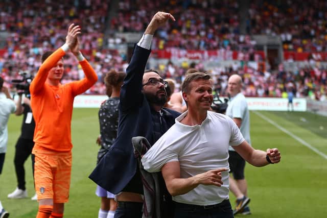 Leeds United's US head coach Jesse Marsch (R) and Leeds director of football Victor Orta (C) celebrate on the pitch after securing Premier League survival (Photo by ADRIAN DENNIS/AFP via Getty Images)