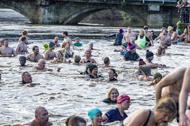 Hardy swimmers brave high water levels, a strong current and a water temperature of 6 degrees by taking part in the annual New Years Day Joe Town - Lilian Rickett Memorial Swim in the River Wharfe at Otley. Picture Tony Johnson