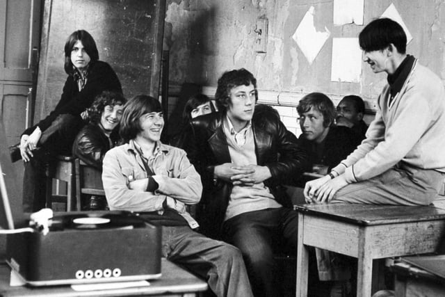 A class of students at Kitson College listen to a record during a general studies period in a classroom with paint and plaster peeling from the walls in June 1971.