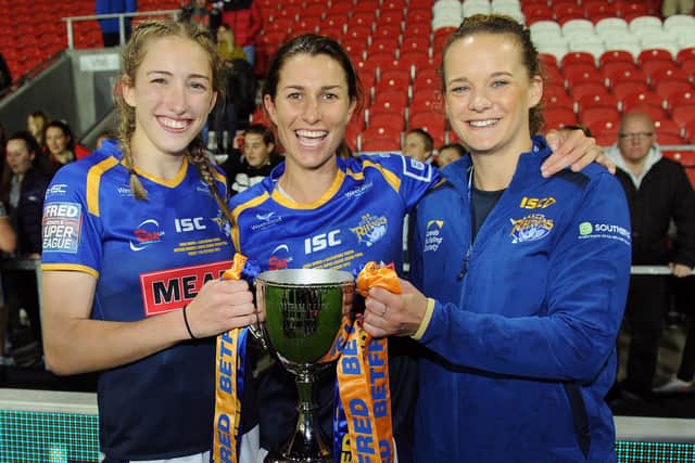 Lois Forsell, right, with Caitlin Beevers, left and captain Courtney Hill following Leeds' 2019 Grand Final win. Picture by Steve Riding.