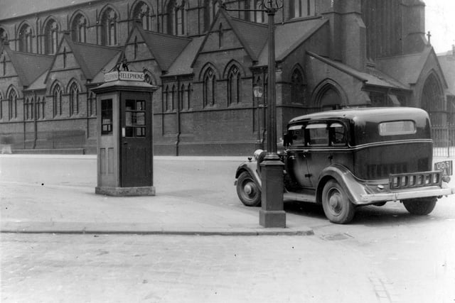 St. Patricks Church at the junction of York Road and Marsh Lane in June 1936. On the corner there is a telephone kiosk and a gas streetlamp. A large black car is visible on the corner.