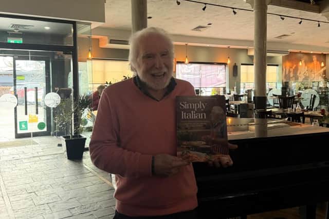 George with his book at the restaurant.