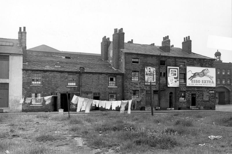 Washing hangs on wasteground in front of Grove Street in June 1953. Buildings on Wellington Street are visible behind, on the far right.