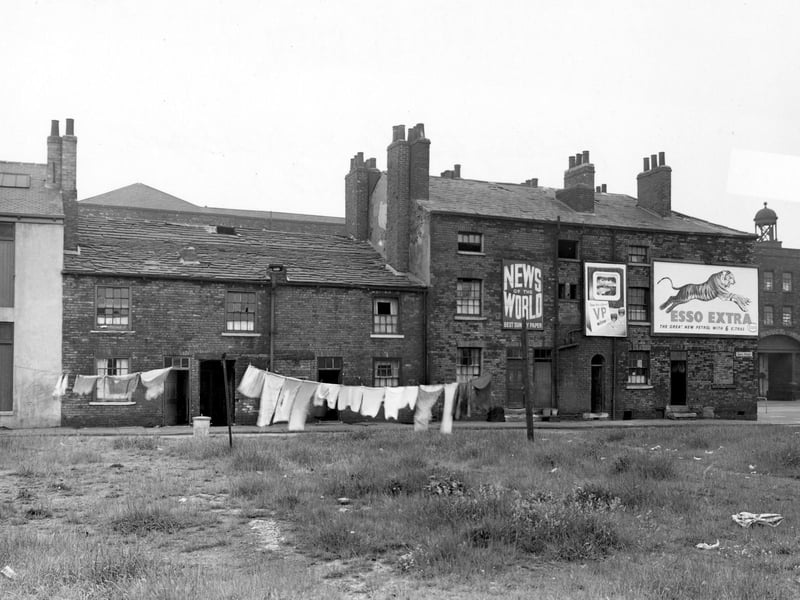 Washing hangs on wasteground in front of Grove Street in June 1953. Buildings on Wellington Street are visible behind, on the far right.