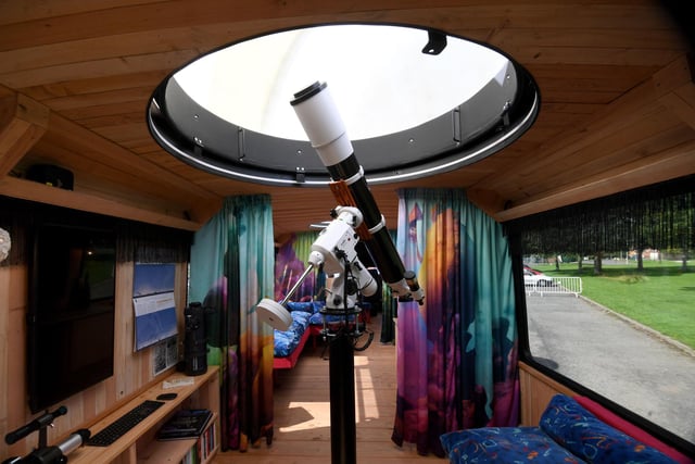 Pictured is the optical telescope fitted with an observatory dome. The interior is a fantastical, multi-sensory, tactile space evoking the surface of an imaginary planet, including: wood panelling using timber from the artists' forest in west Wales, upcycled bus seating, printed silk screens, porcelain lunar lampshades, alien-looking mugs and a sculptural teapot for the kitchen.

 

There is also access to the roof, where the artists have made a dock for comfort.