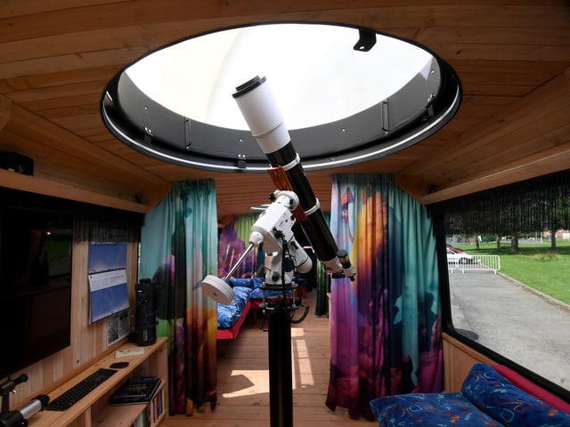 Pictured is the optical telescope fitted with an observatory dome. The interior is a fantastical, multi-sensory, tactile space evoking the surface of an imaginary planet, including: wood panelling using timber from the artists' forest in west Wales, upcycled bus seating, printed silk screens, porcelain lunar lampshades, alien-looking mugs and a sculptural teapot for the kitchen.

 

There is also access to the roof, where the artists have made a dock for comfort.