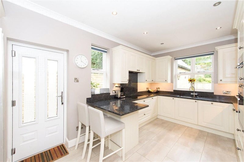 The breakfast kitchen with fitted units and granite worktops includes integrated appliances.
