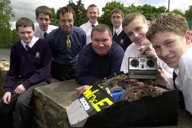 Pupils from Guiseley School have produced a robot with the help of Dixon Motors, Menston in May 2002.  Pictured, from left, are Neil Adams, Matthew Day, Andrew Mangham, design and technology teacher Mike Richmond, Michael Browning, Dixons after-sales manager Liam Shepherd, Chris Eddison and Jake Hutton.