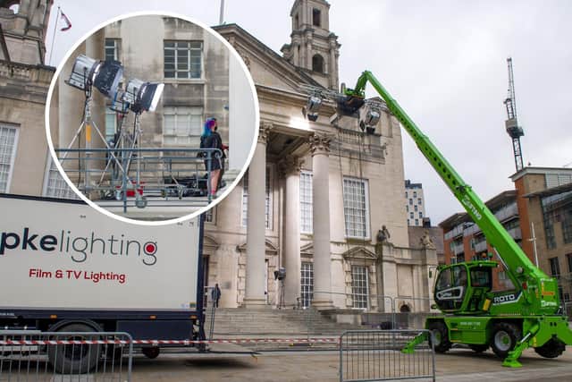 Film crews pictured installing lighting using a crane at Leeds Civic Hall, in Leeds city centre on February 20.