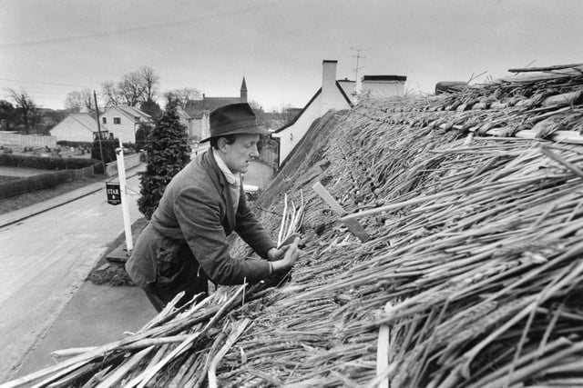 Thatching is renewed at the Star Inn at Harome near Helmsley in January 1988. Thatcher William Tegetmeier carries another sheaf to the roof of one of Yorkshire's famous public houses which is being repaired for the first time in 20 years.