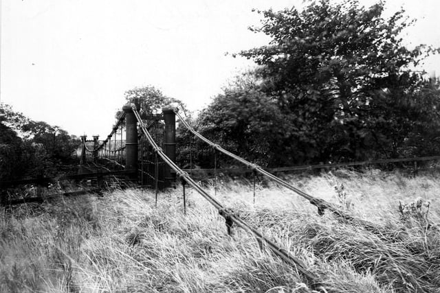 Burley Mills Bridge pictured in September 1950. This was an iron suspension bridge over the river Aire at Burley Mills. It was built by Gott in the early 19th century.
