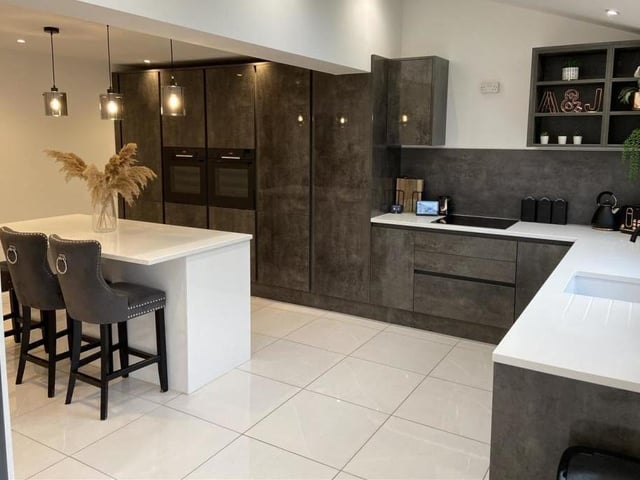 A sleek and stylish kitchen with island and breakfast bar.
