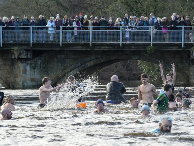 Hardy swimmers brave high water levels, a strong current and a water temperature of 6 degrees by taking part in the annual New Years Day Joe Town - Lilian Rickett Memorial Swim in the River Wharfe at Otley. Picture Tony Johnson