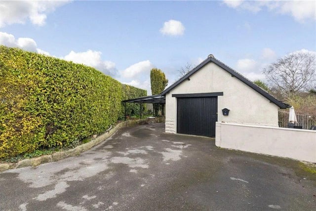There is also ample parking, a car port and substantial matching garage.
