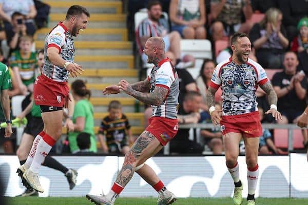 Tom Briscoe, left, celebrates with former Leeds teammate Zak Hardaker, middle and Gareth O'Brien after scoring for Leigh against Warrington in May. Picture by Paul Currie/SWpix.com.