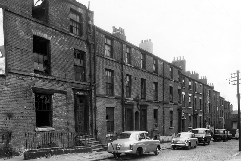 September 1959 and this photo shows a variety of in use and derelict large buildings on St Alban Street. Cars are parked on the street outside, on the left is a car, reg: XUM 417 with a jack underneath. By the late 1970s these buildings were replaced with the Register Office for births, deaths and marriages opened 1979.