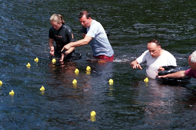 Officials grab the winners of the annual duck race on the River Wharfe at Burley in Wharfedale in June 1998.