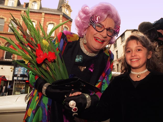 Dame Edna is presented with a bunch of gladioli by Rosha Bassiri, 10, from Alwoodley. The flowers were frequently mentioned in sketches as being the popular character's favourite.