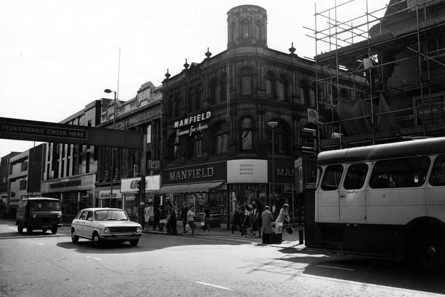 The west side of Briggate showing the junction with Commercial Street in June 1975. In the centre is Manfield footwear, No.52-53 Briggate; to the left of this is Amber ladieswear, No.51, Trueform footwear No.50, and Marks and Spencer, No.45-49. On the right of the picture, hidden behind a bus and scaffolding, is H.Samuel, jewellers.