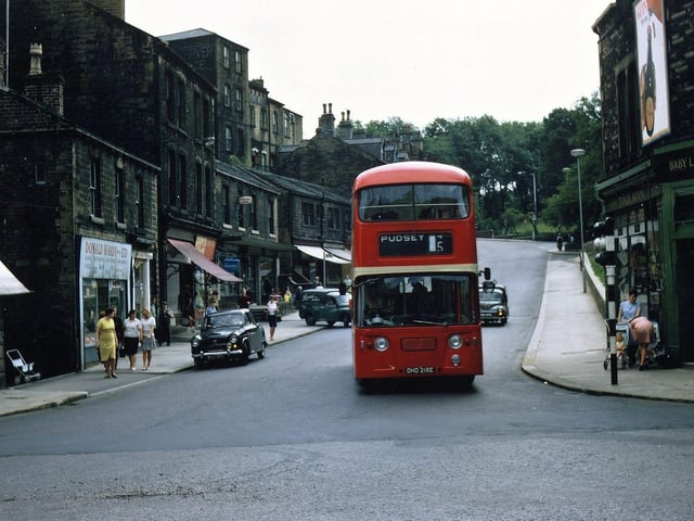 A Pudsey bus (Yorkshire No. 5) passing through Morley Bottoms in August 1967. The view is looking up Scatcherd Hill and shops prominent on it are Donald Hardy, electrical goods, Thompson's newsagents and Misses Toulman, baby linen