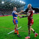 Zak Hardaker, right, shakes hands with Leeds Rhinos captain Cameron Smith after Leigh Leopards' defeat at AMT Headingley last month. Picture by Allan McKenzie/SWpix.com.
