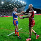 Zak Hardaker, right, shakes hands with Leeds Rhinos captain Cameron Smith after Leigh Leopards' defeat at AMT Headingley last month. Picture by Allan McKenzie/SWpix.com.