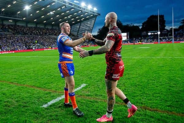 Zak Hardaker, right, shakes hands with Leeds Rhinos captain Cameron Smith after Leigh Leopards' defeat at AMT Headingley last month. Picture by Allan McKenzie/SWpix.com.