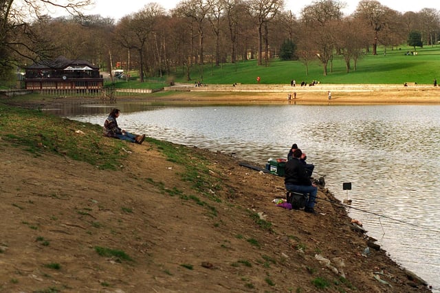 April 1997 and these fishermen at Waterloo Lake are forced to sit on the former bed of the lake some 30ft out from the normal bankside after water level dropped more than ten feet due to a leak.
