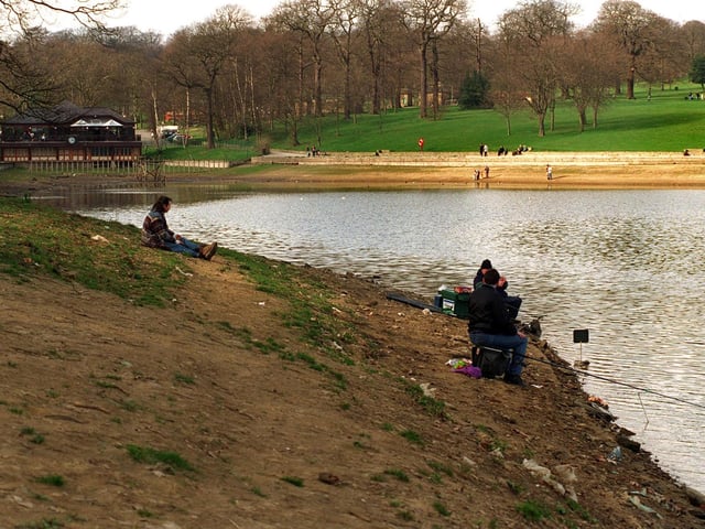 April 1997 and these fishermen at Waterloo Lake are forced to sit on the former bed of the lake some 30ft out from the normal bankside after water level dropped more than ten feet due to a leak.