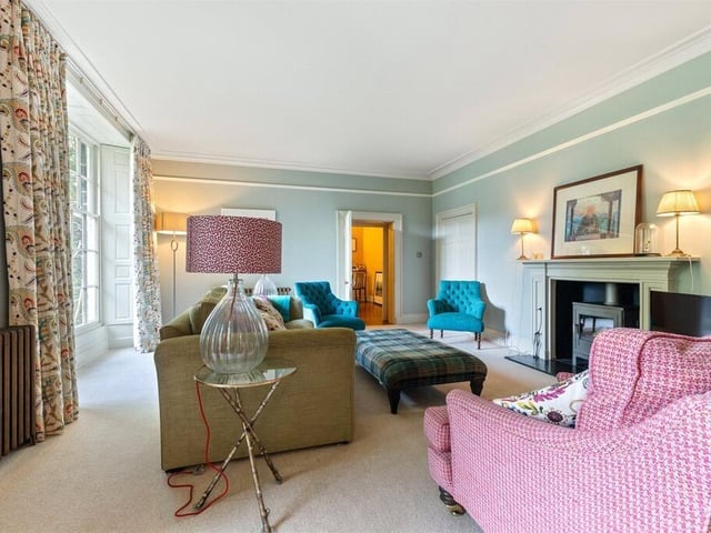 The sitting room offers a feature fire surround with gas stove and the living room to the left incorporates a Chesneys log burning stove.