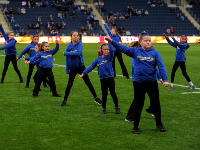 Rhinestones dancers perform on the Headingley pitch.