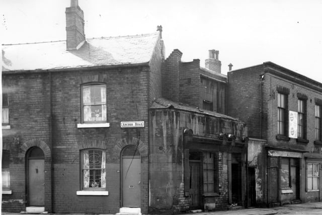Anchor Road is on the left edge, 15 is on the right. This is the junction with Joseph Street. Row of derelict shops in view, number 61 on the right is a fish and chip shop at the corner with Cariss Street. Pictured in April 1964.