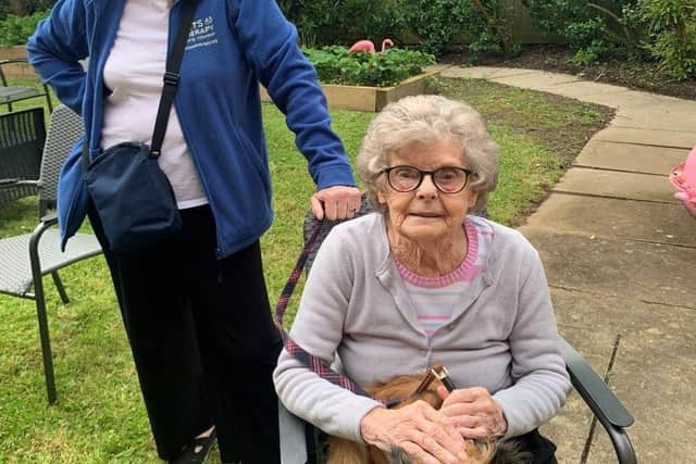 Priory Gardens resident, Barbara Burkinshaw with therapy dog, Luca