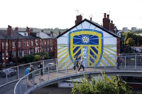 LEEDS, ENGLAND - AUGUST 30: Fans arrive past a mural of the Leeds United club crest on the side of a house prior to the Premier League match between Leeds United and Everton FC at Elland Road on August 30, 2022 in Leeds, England. (Photo by George Wood/Getty Images)