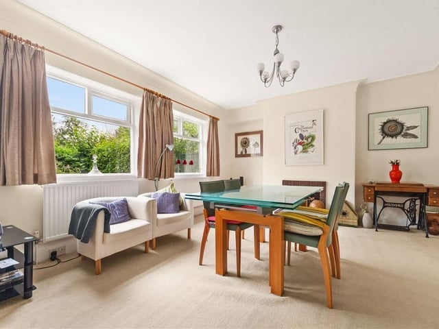 The spacious dining room includes two large windows with views of the garden