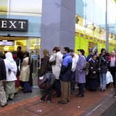 Bargain hunters queue outside Next for the New Year sales on Albion Street, Leeds, on December 27, 2001.