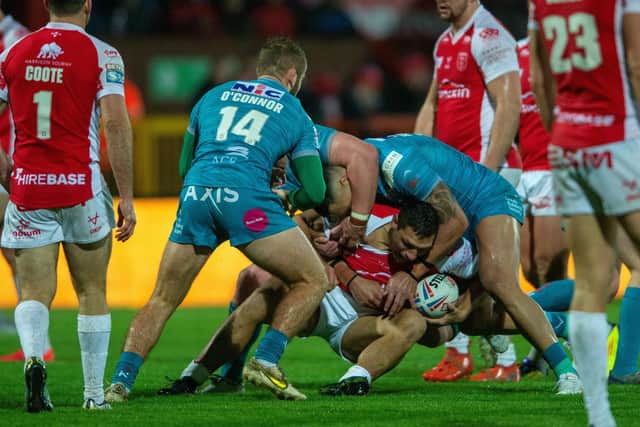 Hull KR's ex-Rhinos winger Ryan Hall is tackled by Jarrod O'Connor and Zane Tetevano during Leeds' defeat at Sewell Group Craven Park in March.  Picture by Bruce Rollinson.