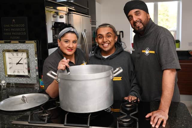Tina Suryavansi, left, is pictured with her son Akash and husband Aky and started helping out at Homeless Hampers to help others because they were so grateful at being able to give the gift of life to their son. Photo: Jonathan Gawthorpe