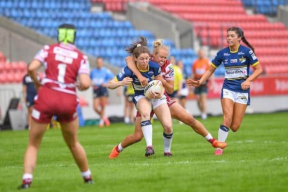 Leeds' Izzy Northrop being tackled by Anna Davies of Wigan during last month's nines tournament at Salford. Picture by Olly Hassell/SWpix.com.