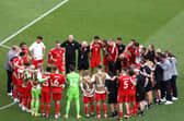 DOHA, QATAR - NOVEMBER 25: Wales players and coaches huddle after the 0-2 loss during the FIFA World Cup Qatar 2022 Group B match between Wales and IR Iran at Ahmad Bin Ali Stadium on November 25, 2022 in Doha, Qatar. (Photo by Catherine Ivill/Getty Images)