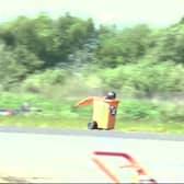 Video grab of Michael Wallhead in his wheelie bin at Elvington Airfield. Picture: Naomi Shaw / SWNS