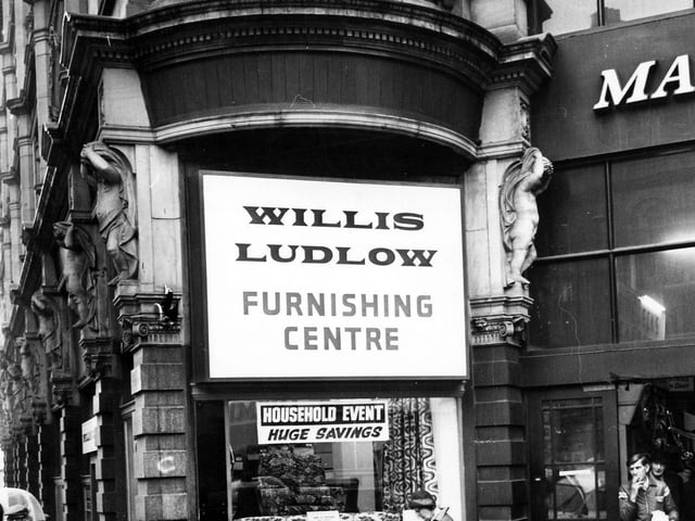 The entrance to Kirkgate Market on the corner of Vicar Lane and Ludgate Hill. In the centre is a shop window of the furnishing department of Willis Ludlow department store, displaying sofas and chairs and advertising 'huge savings'. Pictured in January 1979.