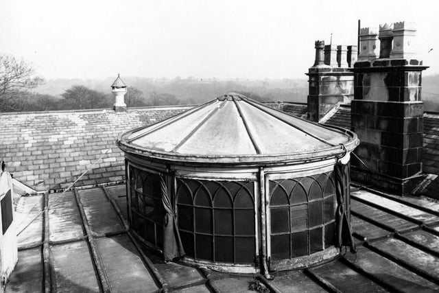 The well decorative headed glass dome with tie back curtains on a rail pictured in March 1945.