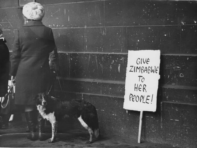 A protest banner leant against a wall in Leeds city centre reads 'Give Zimbabwe to Her People' as in that year guerilla warfare against white rule and the fight for independence had escalated.