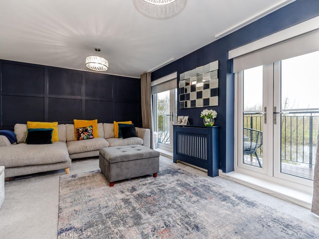 The lounge has doors out to the balcony above the river, with space for dining table and chairs if so desired.
