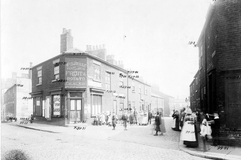 Taken in Waterloo Road looking down Bower Street prior to the Waterloo Road improvements in August 1904.  Bower Street itself contains various residential premises. On Waterloo Road there is W.Savlle, grocers; an advertisement for Jubilee Laundry and Chaplin Hairdressers on the junction with Wales Street. There are many people standing on the road.